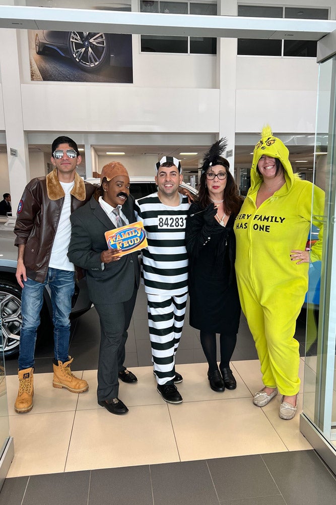 Five people in Halloween costumes: a pilot, Steve Harvey with a Family Feud board, a prisoner, a flapper, and a Grinch